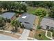 An aerial view of a single-Gathering home showcasing a screened pool, mature landscaping, and a two car garage at 9104 Water Hazard Dr, Hudson, FL 34667
