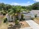 An aerial view highlights this home's beautiful landscaping and well-maintained exterior at 9104 Water Hazard Dr, Hudson, FL 34667