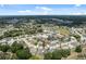 Wide aerial view of homes, road access, community amenities and tree coverage in the surrounding area at 9104 Water Hazard Dr, Hudson, FL 34667