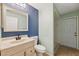 Bathroom featuring a vanity, toilet, mirror, and walk-in shower with neutral color palette at 9104 Water Hazard Dr, Hudson, FL 34667