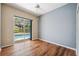Bedroom featuring a sliding glass door to the pool area and a ceiling fan at 9104 Water Hazard Dr, Hudson, FL 34667