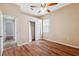 This bedroom features hardwood floors, a ceiling fan, and a closet at 9104 Water Hazard Dr, Hudson, FL 34667
