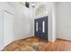 Bright entryway featuring arched double doors, high ceilings, and unique tiled flooring at 9104 Water Hazard Dr, Hudson, FL 34667