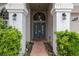 Charming home featuring a double-door entry, mature landscaping, and exterior lighting at 9104 Water Hazard Dr, Hudson, FL 34667