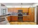 Well-appointed kitchen with wood cabinets, stainless steel appliances, and modern backsplash at 9104 Water Hazard Dr, Hudson, FL 34667