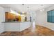Kitchen featuring wood cabinets, pendant lighting, a breakfast bar, and ceramic tile leading to the front door at 9104 Water Hazard Dr, Hudson, FL 34667
