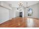 Bright living room featuring a high ceiling, hardwood floors, and large windows at 9104 Water Hazard Dr, Hudson, FL 34667