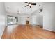 Bright living room with hardwood floors, ceiling fan, and sliding glass doors to the outdoor area at 9104 Water Hazard Dr, Hudson, FL 34667