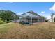 A screened pool area with lush green landscaping offering a private retreat at 9104 Water Hazard Dr, Hudson, FL 34667