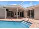 This pool area features a screened enclosure, brick pavers, and a clear blue pool at 9104 Water Hazard Dr, Hudson, FL 34667