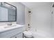 Updated bathroom features modern vanity, decorative textured wall, and shower over tub at 9141 Greenbriar Ln, Port Richey, FL 34668