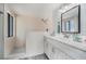 Bathroom featuring a walk-in shower, modern vanity, and stylish fixtures at 9141 Greenbriar Ln, Port Richey, FL 34668