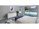 Bedroom with sliding glass doors with a view of the swimming pool and neutral-colored walls at 9141 Greenbriar Ln, Port Richey, FL 34668