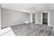 Open bedroom featuring gray walls and luxury vinyl floors and access to a bathroom and closet at 9141 Greenbriar Ln, Port Richey, FL 34668