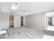 Open bedroom featuring gray walls and luxury vinyl floors and access to a bathroom and closet at 9141 Greenbriar Ln, Port Richey, FL 34668