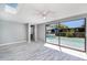 Bright bedroom featuring a skylight, ceiling fan, and sliding glass doors leading to a pool at 9141 Greenbriar Ln, Port Richey, FL 34668