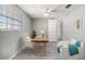 Cozy bedroom with a window, desk, and seating, creating a comfortable and inviting space at 9141 Greenbriar Ln, Port Richey, FL 34668