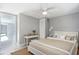 Bedroom with wood-look floors, ceiling fan, closet, and a view into the hallway at 9141 Greenbriar Ln, Port Richey, FL 34668