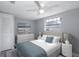 Charming bedroom with neutral decor, plush bedding, and plenty of natural light at 9141 Greenbriar Ln, Port Richey, FL 34668