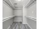 Walk-in closet featuring built-in shelves and ample storage space at 9141 Greenbriar Ln, Port Richey, FL 34668