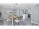 Dining room with seating for six, and an open floor plan connects to the kitchen island at 9141 Greenbriar Ln, Port Richey, FL 34668