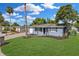 Charming single-story home with blue exterior, well-manicured lawn, and a lovely mailbox at 9141 Greenbriar Ln, Port Richey, FL 34668