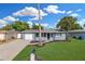 Charming single-story home with blue exterior, well-manicured lawn, and a lovely mailbox at 9141 Greenbriar Ln, Port Richey, FL 34668
