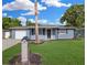 Charming single-story home with blue exterior, well-manicured lawn, and a lovely mailbox at 9141 Greenbriar Ln, Port Richey, FL 34668