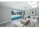 Living room with a pool view through sliding glass doors, skylights, and vinyl flooring at 9141 Greenbriar Ln, Port Richey, FL 34668