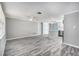 Open-concept living area featuring wood flooring, and connecting seamlessly to the kitchen island at 9141 Greenbriar Ln, Port Richey, FL 34668