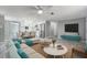 Bright open-concept living room and kitchen, featuring modern furnishings and stainless steel appliances at 9141 Greenbriar Ln, Port Richey, FL 34668