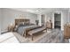 Bedroom features neutral walls, a ceiling fan, and a walk-in closet for ample storage at 9141 Greenbriar Ln, Port Richey, FL 34668