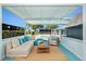 This stylish covered patio is an entertainer's dream, overlooking the stunning backyard pool at 9141 Greenbriar Ln, Port Richey, FL 34668