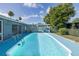 Enjoy the pool in this backyard with a covered patio and lush landscaping for privacy at 9141 Greenbriar Ln, Port Richey, FL 34668