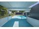 The pool area features a covered patio perfect for relaxing and enjoying the outdoor space at 9141 Greenbriar Ln, Port Richey, FL 34668