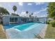 Gorgeous swimming pool surrounded by an aqua deck, mature trees and perfect for outdoor enjoyment at 9141 Greenbriar Ln, Port Richey, FL 34668