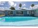 Large backyard pool is surrounded by a cool blue deck that provides a private oasis for swimming at 9141 Greenbriar Ln, Port Richey, FL 34668