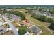 Aerial shot of home situated near golf course and lake, highlighting its location in the neighborhood at 9208 Butler Blvd, Weeki Wachee, FL 34613