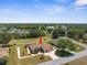 Aerial view of home featuring lush landscaping, screened pool, and mature trees at 9208 Butler Blvd, Weeki Wachee, FL 34613
