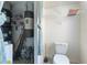 Small, utility bathroom with storage, toilet, and utility features at 9208 Butler Blvd, Weeki Wachee, FL 34613