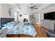 Spacious bedroom with light-colored walls, a comfortable bed, and a TV, perfect for relaxation and rest at 9208 Butler Blvd, Weeki Wachee, FL 34613