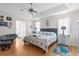 Bright bedroom features a comfy bed, ceiling fan, and ample natural light, providing a peaceful retreat at 9208 Butler Blvd, Weeki Wachee, FL 34613