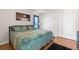 Bedroom with a comfortable bed, warm lighting, and functional closet space at 9208 Butler Blvd, Weeki Wachee, FL 34613