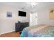Comfortable bedroom featuring wood floors, TV, dresser, and cool colors throughout at 9208 Butler Blvd, Weeki Wachee, FL 34613