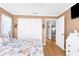 Bedroom with coastal decor, closet with sliding doors, and view into the dining area at 9208 Butler Blvd, Weeki Wachee, FL 34613