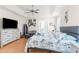 Bright bedroom features a comfy bed, ceiling fan, TV and ample natural light, creating a peaceful retreat at 9208 Butler Blvd, Weeki Wachee, FL 34613