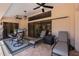 A covered patio features outdoor dining and lounge seating, ceiling fans, and a large sliding glass door at 9208 Butler Blvd, Weeki Wachee, FL 34613