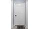 A white six-panel door with black hardware set against light blue walls with trim at 9208 Butler Blvd, Weeki Wachee, FL 34613