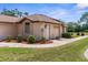Garage side of home with mature landscaping and inviting exterior details at 9208 Butler Blvd, Weeki Wachee, FL 34613