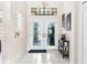 Bright foyer features tiled floors, decorative lighting, and a stylish entryway table at 9208 Butler Blvd, Weeki Wachee, FL 34613